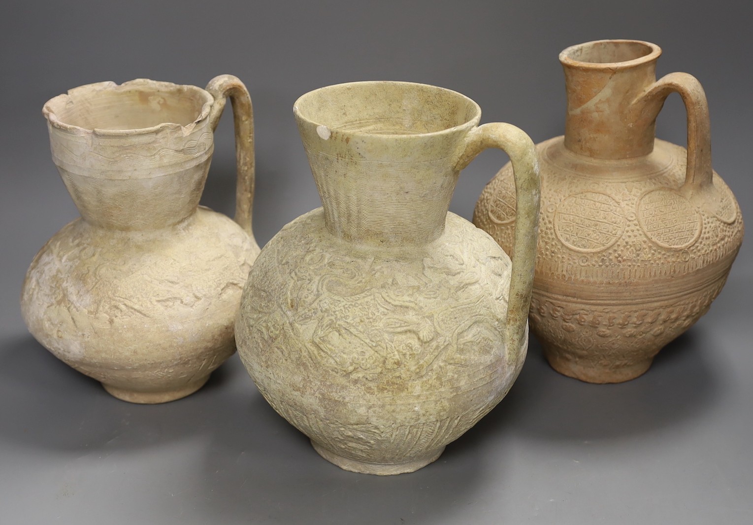 A selection of four Islamic terracotta jugs, Middle Eastern, possibly 12th century AD, The tallest 25 cm